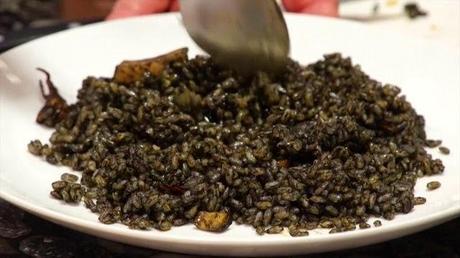 Arroz negro en paella (traditional black rice paella,  mediterranean style)