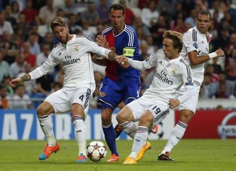 Basel's Streller challenges for the ball with Real Madrid's Ramos, Pepe and Modric during their Champions League soccer match in Madrid