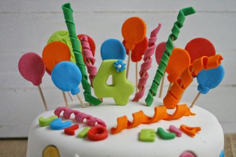 Tarta de cumpleaños con globos y confetis
