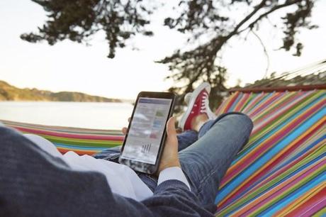 Woman works on HP Stream 8 tablet while in a hammock outdoors.