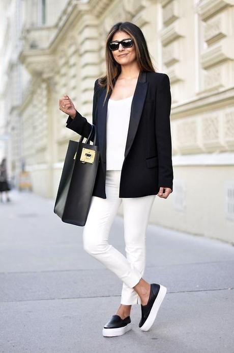 Pair a black blazer with white slim trousers to effortlessly deal with whatever this day throws at you. Black leather slip-on sneakers will contrast beautifully against the rest of the look. Shop this look for $98: http://lookastic.com/women/looks/blazer-and-skinny-pants-and-slip-on-sneakers-and-tote-bag-and-tank-and-sunglasses/2958 — Black Blazer — White Skinny Pants — Black Leather Slip-on Sneakers — Black Leather Tote Bag — White Tank — Black Sunglasses