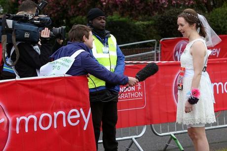 A-woman-who-plans-to-be-married-half-way-through-the-race-is-interviewed-by-the-start-line-of-the-London-Marathon