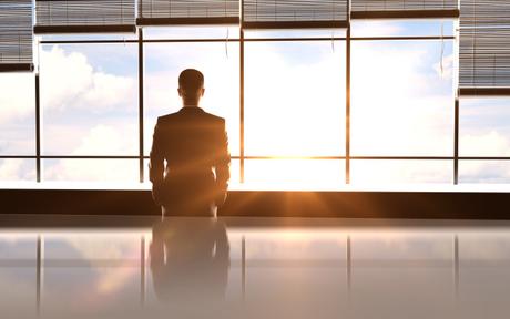 businessman standing in sunny office