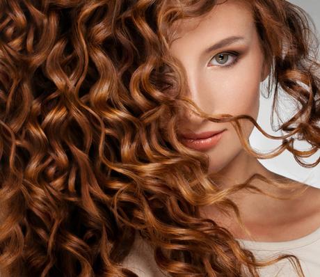 Beautiful young woman with long curly hairs