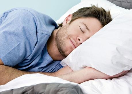 Man comfortably sleeping in his bed