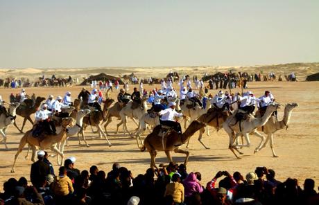 Tunisia camel riders entertain the crowd in the Douz desert.