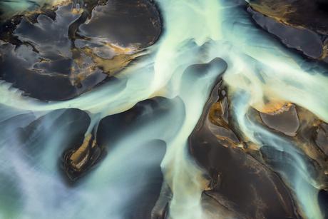 Water in Iceland's Ölfusá River flows around sandbars towards the Atlantic Ocean, July 7th 2014. The Ölfusá is Iceland's largest river and its watershed drains 6100 square kilometers or 1/7th of Iceland, including the Langjökull glacier. According to a recent study by the University of Arizona to be published in Geophysical Research Letters, parts of Iceland are rising as much as 35mm per year; this is directly related to the melting of Iceland's glaciers and to global warming.