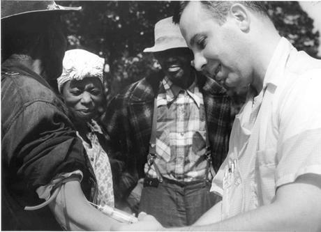 Unidentified subject, onlookers and Dr. Walter Edmondson taking a blood test (NARA, Atlanta, GA)