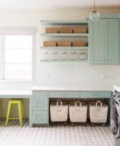 Ashley Winn Design -Fantastic laundry room features gray green cabinets