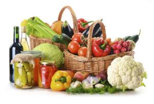 Composition with wicker basket and grocery isolated on white