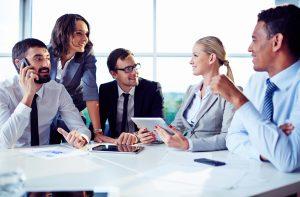 Happy co-workers discussing ideas in office