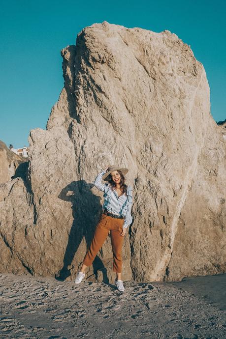 stripped_blouse-camel_trousers-lack_of_color_hat-wanderlust_jewels-matador_beach-malibu-golden_goose_sneakers-street_style-collage_vintage-129