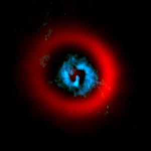 Espirales dentro de un surco en el disco de polvo de una estrella en formación Espirales dentro de un surco en el disco de polvo de una estrella en formación