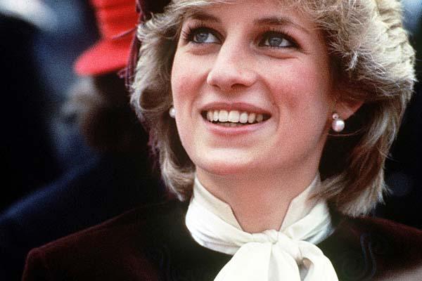 KATE MIDDLETON Wedding Dress Update: JASPER CONRAN Among Four Royal Gown Designers The late Princess Diana during a visit to St Austell, Cornwall, in October 1983. She is wearing a deep plum velvet suit designed by Jasper Conran.