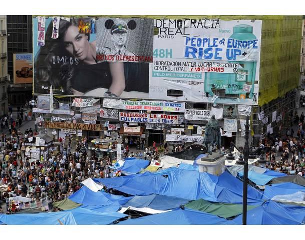 DEMOCRACIA REAL, YA! A view of the central Puerta del Sol square filled with banners and tarps erected by demonstrators in Madrid