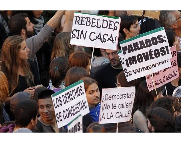 DEMOCRACIA REAL, YA! Demonstrators hold up banners during protest in Madrid's Puerta del Sol