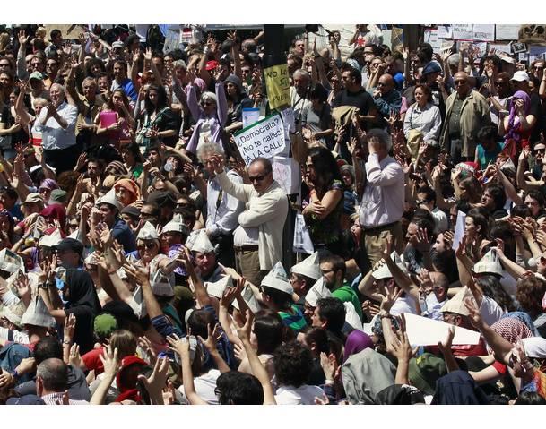DEMOCRACIA REAL, YA! Demonstrators listen to a speaker in Madrid's famous landmark Puerta del Sol
