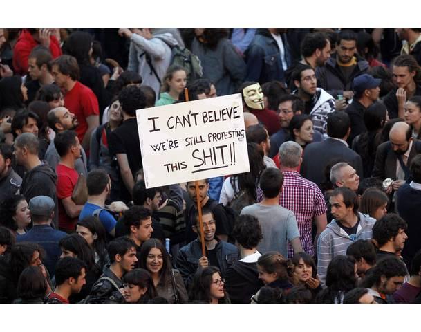 DEMOCRACIA REAL, YA! Demonstrator holds up a sign during protest in Madrid's Puerta del Sol