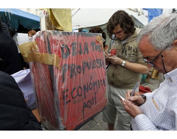 DEMOCRACIA REAL, YA! People write proposals on the economy in Madrid's Puerta del Sol