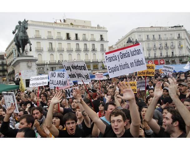 DEMOCRACIA REAL, YA! Demonstrators gather and shout slogans in Madrid's famous landmark Puerta del Sol