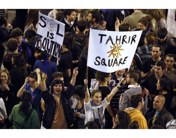 DEMOCRACIA REAL, YA! Demonstrators hold up banners in Madrid's famous landmark Puerta del Sol