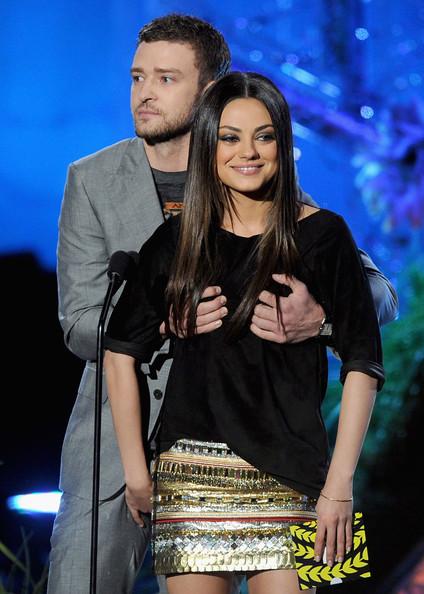 Actors Justin Timberlake (L) and Mila Kunis present an award onstage during the 2011 MTV Movie Awards at Universal Studios' Gibson Amphitheatre on June 5, 2011 in Universal City, California.