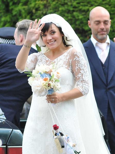 Lily Allen THE HAPPY COUPLE! Lily Allen and Sam Cooper emerge from St James The Great Church in Cranham after their wedding. Lily was wearing a Chanel lace dress created by Karl Lagerfeld and was looking estatically happy following her marriage to Sam.  The singer-turned-businesswoman was carrying a bouquet with a knitted bride and groom hanging from the stems.