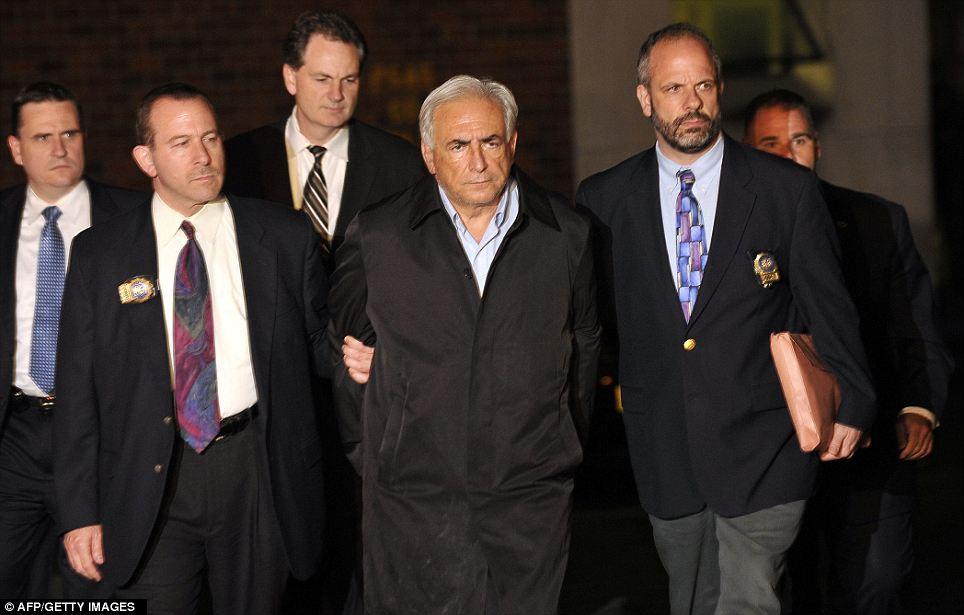 SHOCK: IMF head Dominique Strauss-Kahn, centre, is taken out of a police station in New York on May 15. He was charged with attempting to rape a New York chambermaid