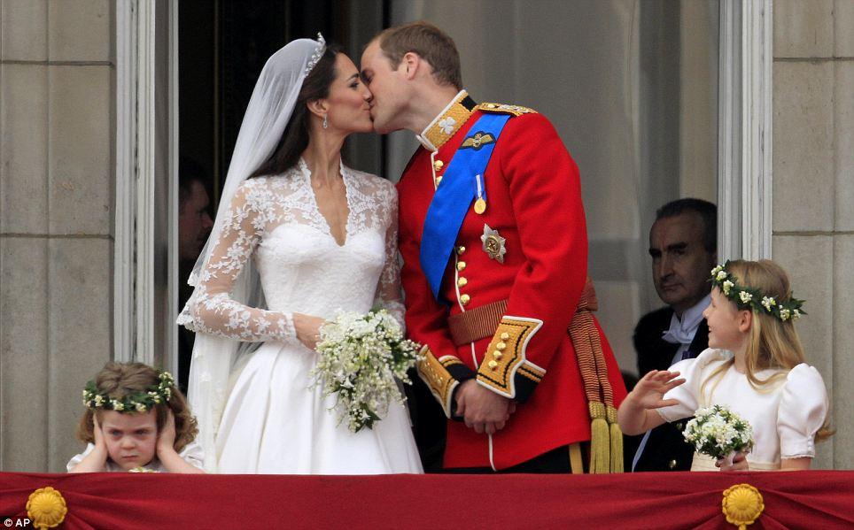 EAR WE GO: As Prince William kisses his wife Kate, Duchess of Cambridge, on the balcony of Buckingham Palace, it all proves too much for bridesmaid Grace van Cutsem, left, who covers her ears 