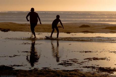 Father and son playing and bonding on Bogey-Board on Morro Strand State Beach