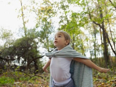 Boy (5-6) wearing cape