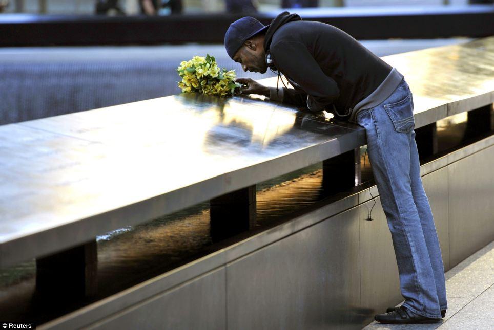 Struggle: Dennis Swindell leans over to kiss the inscribed name of his partner, Gary Lee Bright, on the South Tower pool wall