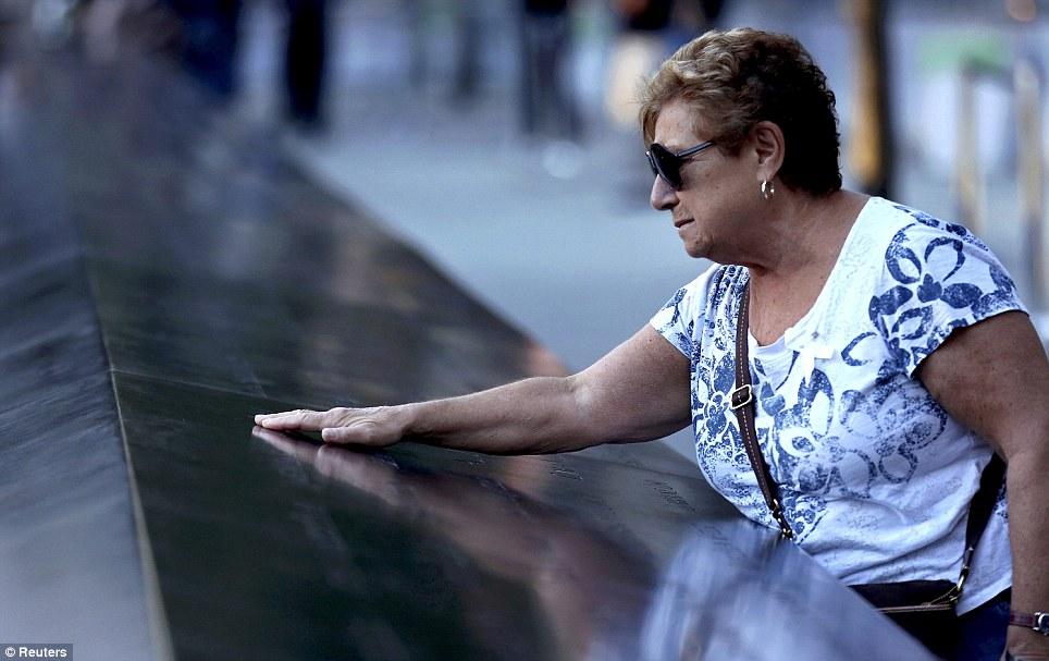 Missed: Amelia Tedesco of Staten Island, New York, touches the inscribed name of her son-in-law Walter Baran during ceremonies marking the 11th anniversary of the 9/11 attacks on the World Trade Center