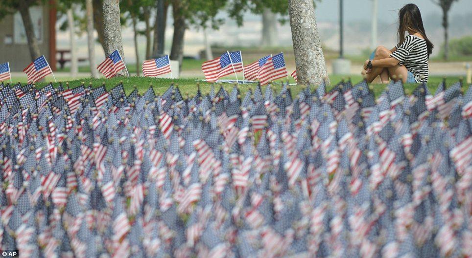 Field: A visitor at Victor Valley College in Victorville, California sits among the tribute there