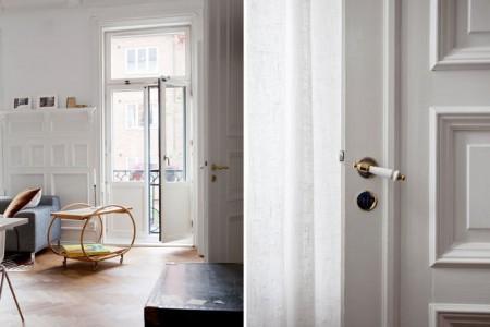 techos altos molduras suelo espigado madera roble salón comedor nórdico rodapíes altos madera revista hsm madrid puertas dobles paneladas blancas paredes paneladas madera muebles de diseño mobiliario moderno mobiliario diseño grandes ventanales estilo nórdico elementos arquitectónicos clásicos diseño nórdico diseño escandinavo diseño de interiores delikatissen revista hsm madrid decoración nórdica decoración interiores nórdico 