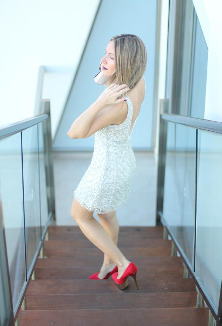 Idea de look para una cena de Navidad: vestido de encaje color plata y zapatos de tacón rojos