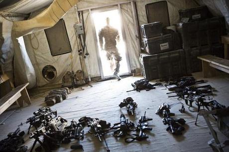 A soldier from 1st Platoon, Alpha Company, 1st Battalion, 36th Infantry leaves a room while checking the inventory of weapons at Strong Point DeMaiwand