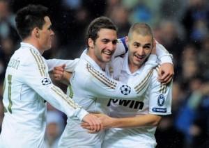 MADRID, SPAIN - NOVEMBER 22:  Karim Benzema (R) of Real Madrid celebrates with Gonzalo Higuain (C) and Jose Callejon and  after scoring his team's 6th goal  team's 6th goal during the UEFA Champions League group D match between Real Madrid and Dinamo Zagreb at Estadio Santiago Bernabeu on November 22, 2011 in Madrid, Spain.  (Photo by Denis Doyle/Getty Images)