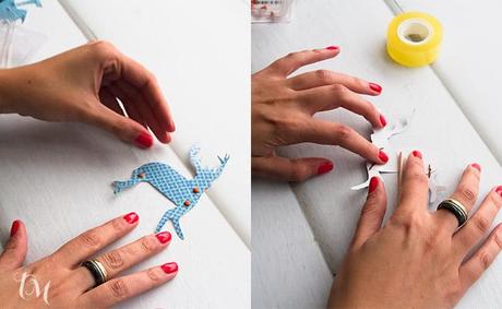 poniendo tachuelas en los animales de papel poniendo tachuelas de colores en los animales de papel