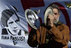 Una mujer agita la bandera de Portugal con una escoba el 20 de mayo de 2013, pidieon la dimisión del gobierno portugués.