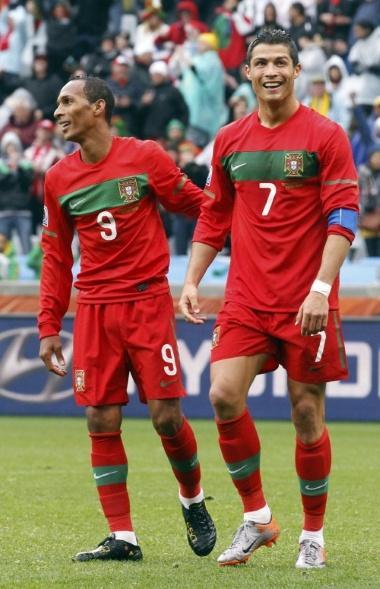 Portugal's Cristiano Ronaldo smiles beside team mate Liedson as he celebrates his goal against North Korea during the 2010 World Cup group G soccer match at Green Point stadium in Cape Town June 21, 2010. REUTERS/Jose Manuel Ribeiro (SOUTH AFRICA - Tags: SPORT SOCCER WORLD CUP)