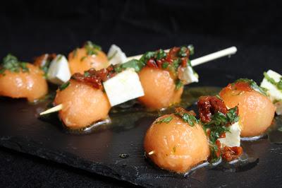 Brochetas de cantaloupe y mozarella con vinagreta de albahaca y tomates secos