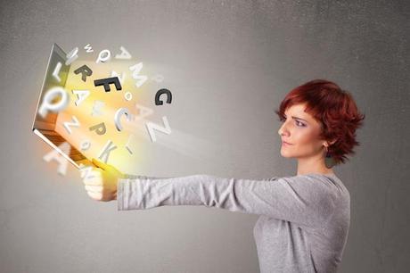 Young lady hoolding notebook with colorful abstract letters