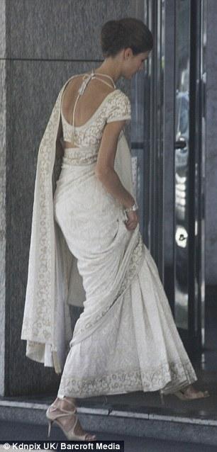 Kendra, 24, wears an ivory sari with intricate gold embroidery to marry Prince Rahim