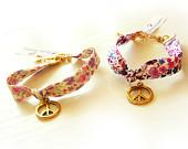 Gold Peace Charm Bracelet with Liberty Flower Ribbon