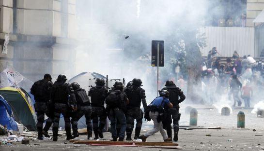 Police officers clash with demonstrators outside the Municipal Chamber during the teacher's strike in Rio de Janeiro