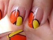 Manicura naranja amarillo, borde negro.
