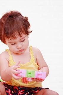 Niña jugando con bloques de construcción.