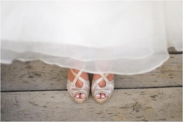 bride's shoes peeking out from beneath the wedding dress, pink and purple romantic rustic wedding, Sunny Studios