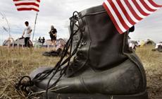 Boot with US flag in it rests on ground in memorial gravesite at anti-war protest near President Bush's ranch in Crawford